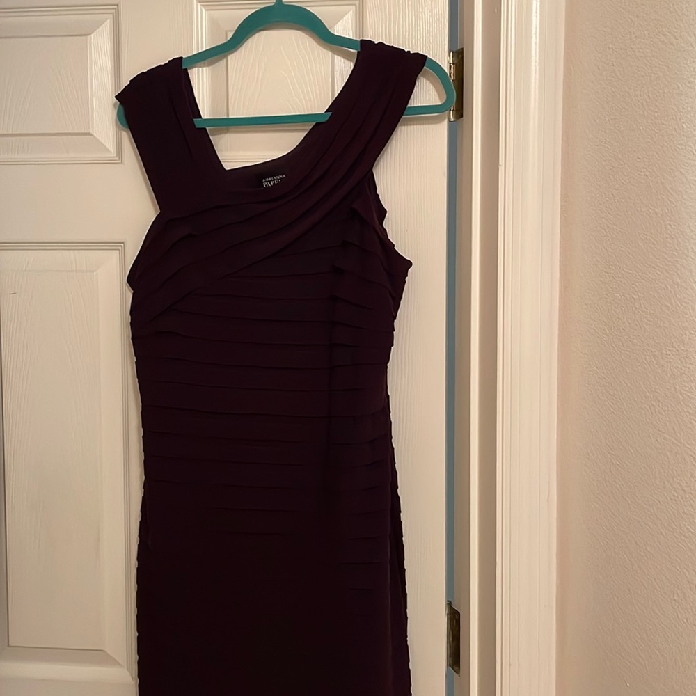 Sexy figure flattering knee length eggplant-colored party dress.
